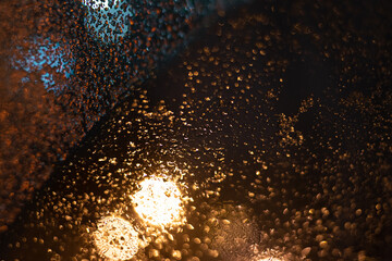 Blurred background with raindrops and lights.