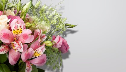 Fresh beautiful flowers on light gray table background.