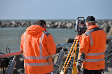 Surveyor workers with geodesy equipment device