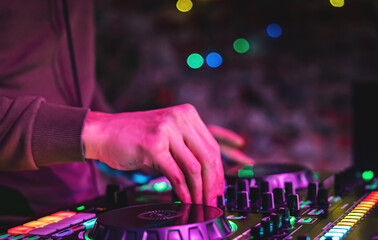 Fototapeta na wymiar DJ Hands creating and regulating music on dj console mixer in concert nightclub