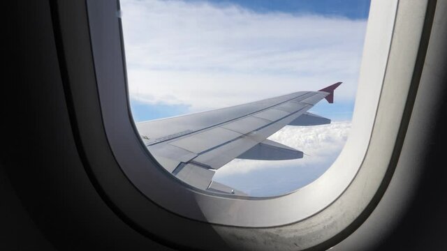 Airplane wing. Looking through plane window. Travel concept