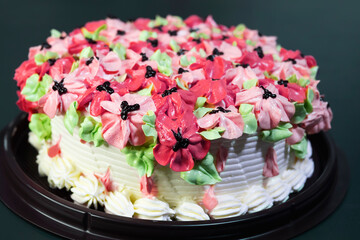 Obraz na płótnie Canvas ฺBeautiful butter cake with colorful pink flower decoration on top
