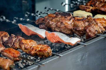 Grill fish and meat on a skewer. BBQ fish and meat