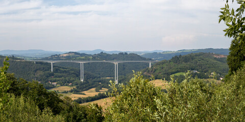 Fototapeta na wymiar Bridge in beautiful valley, typical french countryside with mountains and forest, France, Europe