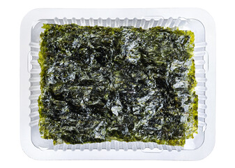 Crispy nori seaweed korean snack in a plastic container isolated on white background. With clipping path.