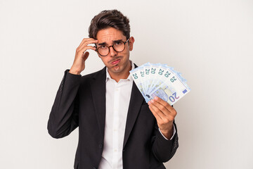 Young mixed race business man holding bills isolated on white background being shocked, she has remembered important meeting.