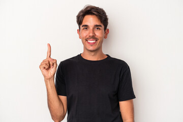 Young mixed race man isolated on white background showing number one with finger.