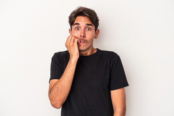 Young mixed race man isolated on white background biting fingernails, nervous and very anxious.