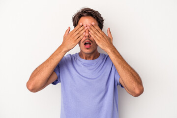 Young mixed race man isolated on white background afraid covering eyes with hands.