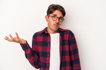 Young mixed race man isolated on white background doubting and shrugging shoulders in questioning...
