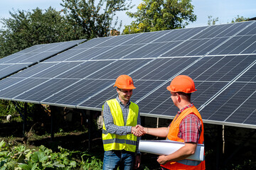 Two professional contractors discuss final result at solar panel installation
