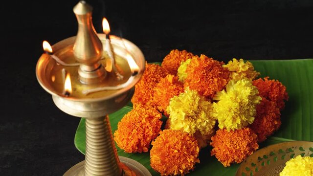 Onam Diwali vishu celebration Indian festival marigold flowers flowerbed lighted oil lamp Nilavilakku decoration 4K video footage Rangoli Dipavali Kerala Tamil nadu North India Mumbai Delhi India