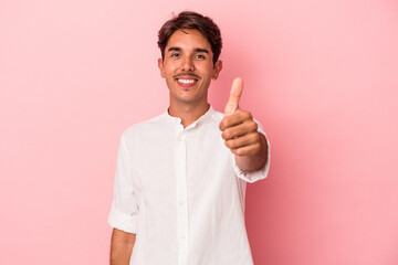 Young mixed race man isolated on white background smiling and raising thumb up