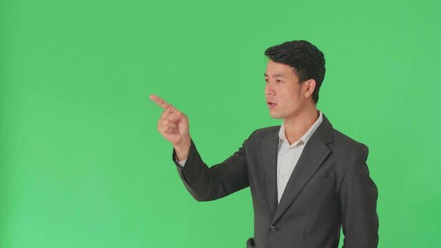 Asian Business Man Threatening With Finger In The Green Screen Studio
