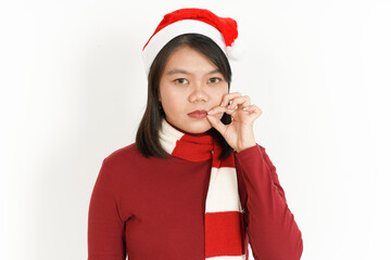 Keep Secret lip shut of Beautiful Asian Woman Wearing Red Turtleneck and Santa Hat Isolated On White Background