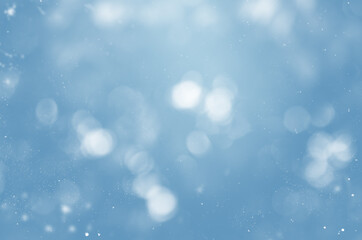blurry blue background with snowflakes and bokeh