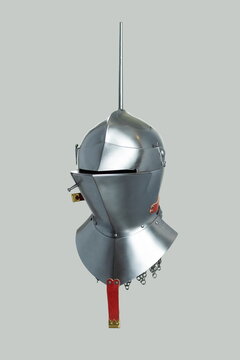 Medieval knightly Milanese helmet with a heraldic kleinod in the form of a swan and a crown, period of the 15th century, on a light background.