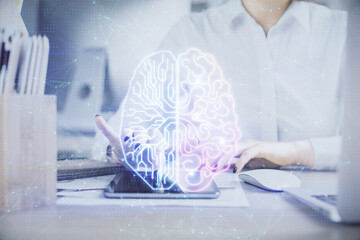 Double exposure of brain sketch hologram and woman holding and using a mobile device.