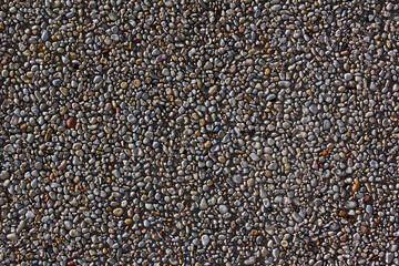 Gravel stones pebbles and concrete wall for background