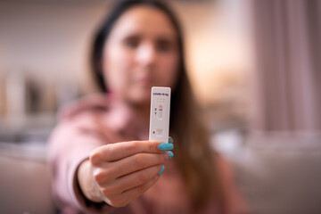 Girl holding a corona virus SARS-Cov-2 rapid antigen test