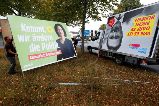 Workers remove election campaign posters after general election in Germany