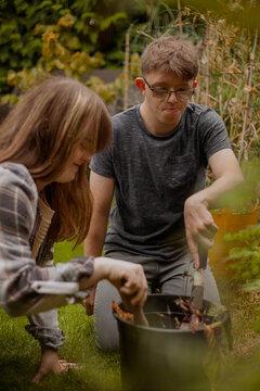 Young couple with Down Syndrome and Foetal Alcohol Syndrome gardening together and having fun