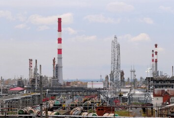 An oil and gas processing plant. Factory buildings, production pipes, railway tanks. Panorama of a...