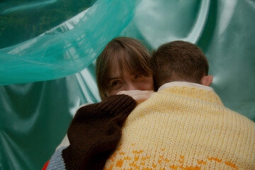 Young woman with Down Syndrome hugging and smiling