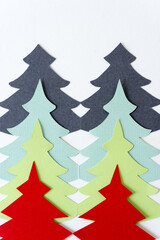 abstract christmas trees in gray, green mint, celery green, and red on a light background
