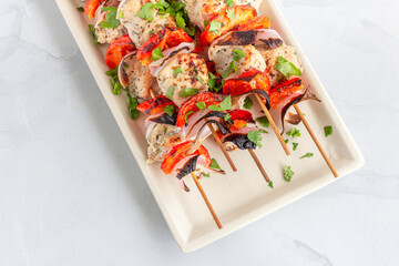 Chicken Kebab on the Skewers on a Platter Close Up Top Down Photo