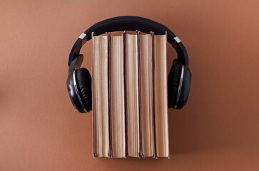 Audiobooks. Headphones and books. Education, study. Old book. Self-education concept. View from above. Student. Intelligence. Knowledge library