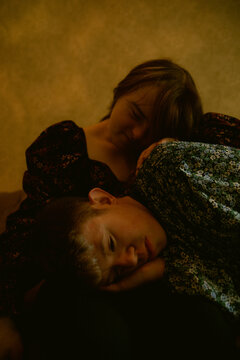 Young couple with Down Syndrome and Foetal Alcohol Syndrome resting heads on each other with eyes closed