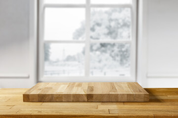 Wooden desk of free space and winter window background. 