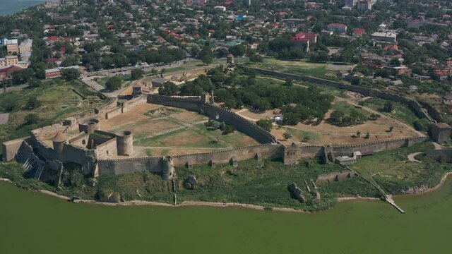 Belgorod-Dnestrovskaya fortress from a bird's eye view. The largest fortress in Ukraine is located on the Dniester River. Green blooming water and white-stone walls of the fortress.