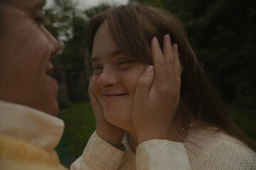 Portrait of young woman with Down Syndrome looking at her boyfriend and smiling