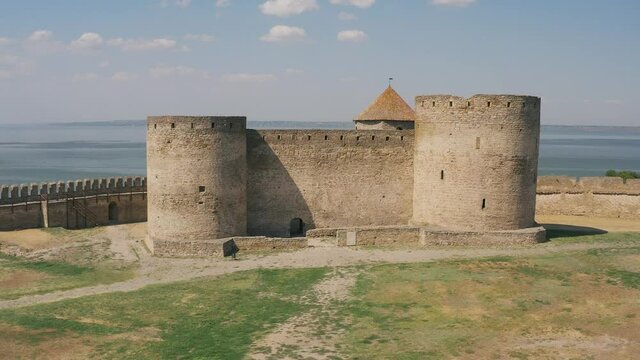 Belgorod-Dnestrovskaya fortress from a bird's eye view. The largest fortress in Ukraine is located on the Dniester River. Green blooming water and white-stone walls of the fortress.