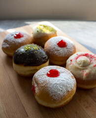Doughnuts with different types of fillings close up photo. Authentic Israeli doughnut - sufgania. Symbols of Hanukkah fest.