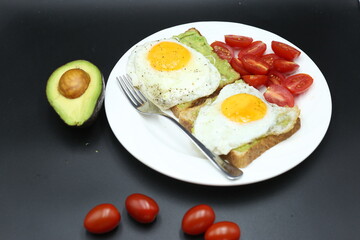 Vegetarian toast with egg and avocado, toast bread, black background