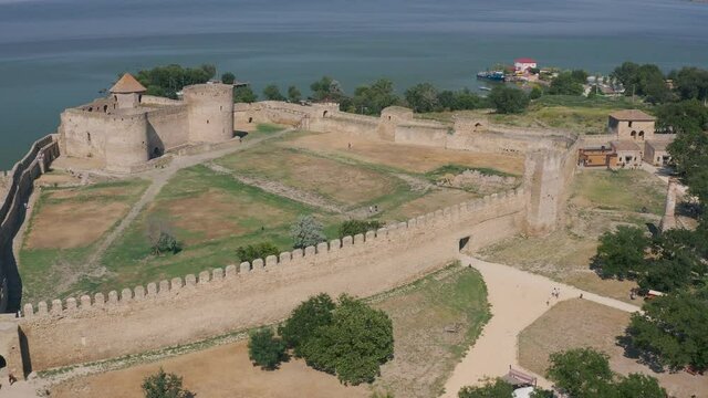 Belgorod-Dnestrovskaya fortress from a bird's eye view. The largest fortress in Ukraine is located on the Dniester River. Green blooming water and white-stone walls of the fortress.