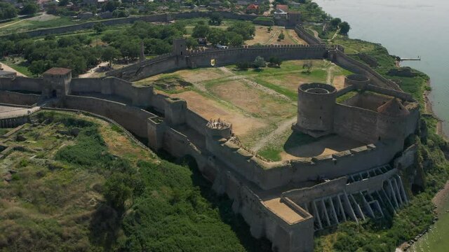 Belgorod-Dnestrovskaya fortress from a bird's eye view. The largest fortress in Ukraine is located on the Dniester River. Green blooming water and white-stone walls of the fortress.