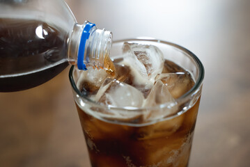 close up shot. person pouring soda to glass and many soda pop