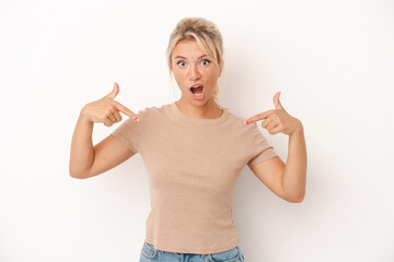 Young Russian woman isolated on white background points down with fingers, positive feeling.