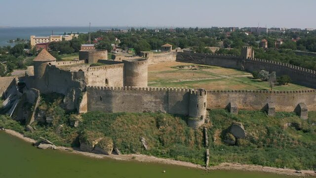 Belgorod-Dnestrovskaya fortress from a bird's eye view. The largest fortress in Ukraine is located on the Dniester River. Green blooming water and white-stone walls of the fortress.