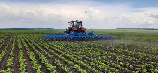 Spring farming concept; one tractor with cultivator in agricultural field