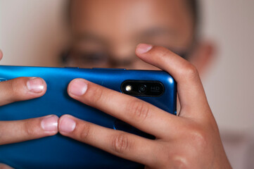 close up of a boy holding a smartphone