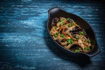 Asian style- restaurant background. Udon noodles with beef Wok