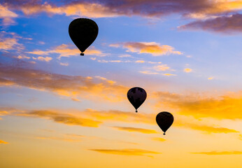 Three hot air balloons at dusk in Temecula CA