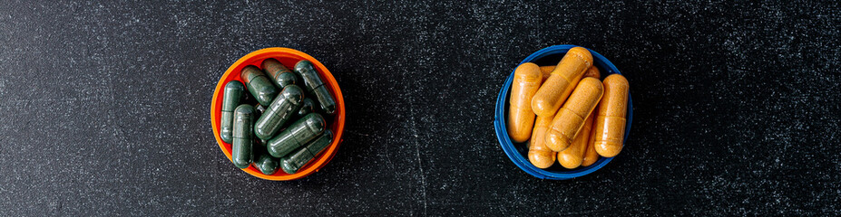chlorophyll and b-complex supplement capsules on chalkboard background. immune prevention care...