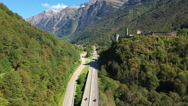 Mesocco castle ruins overlooking the road of the San Bernardino mountain pass in canton Graubunden in Switzerland. Shot with a forward motion. 