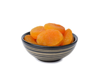 Dried apricots in ceramic bowl on white background